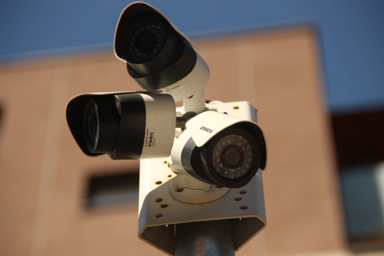 mobile-01 High-resolution surveillance cameras installed in a city environment for security purposes.